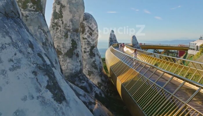 Elegant 4K Drone Flyover of Da Nang Golden Bridge Amid Lush Greenery with Model walking