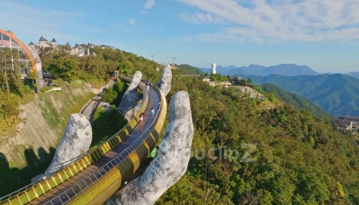 Smooth Drone Flyover Highlighting Da Nang Golden Bridge at Golden Hour
