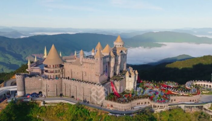 4K Drone Flyover of Ba Na Hill French Castle with Scenic Mountain Background