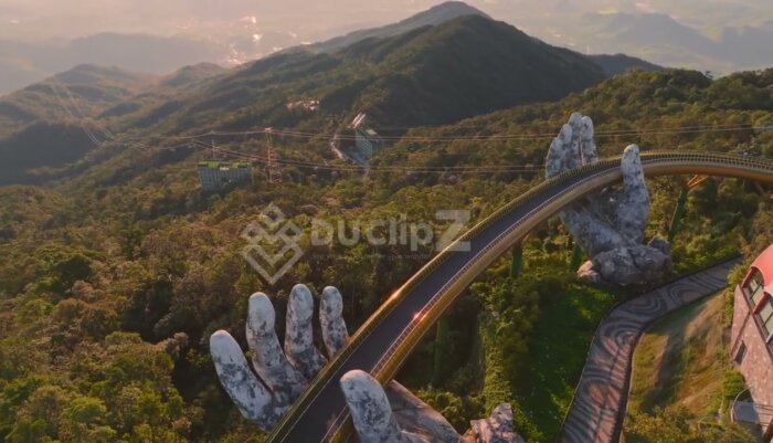 Cinematic 4K Drone Flyover of Da Nang Golden Bridge with Mountain Background