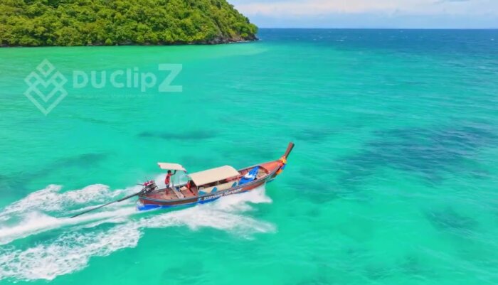 Serene Aerial View of Boat Sailing Over Koh Phi Phi Crystal Waters