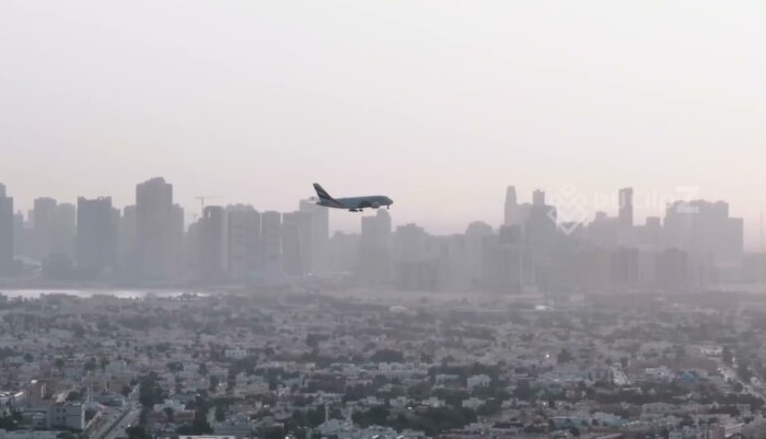Smooth 4K Drone Footage of a Plane Landing in Dubai Skyline