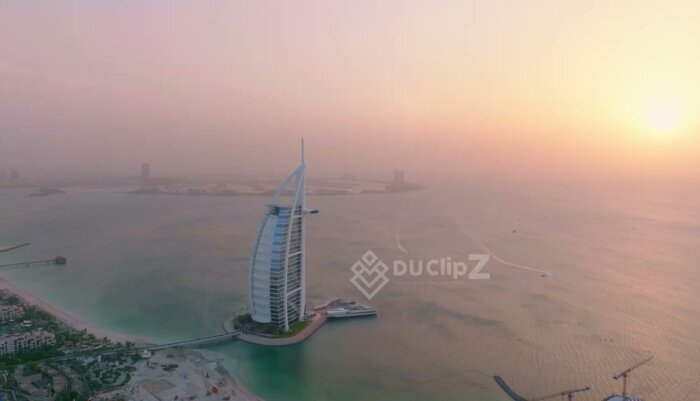 Smooth 4K Drone Panorama of Burj al Arab at Sunrise Golden Hour