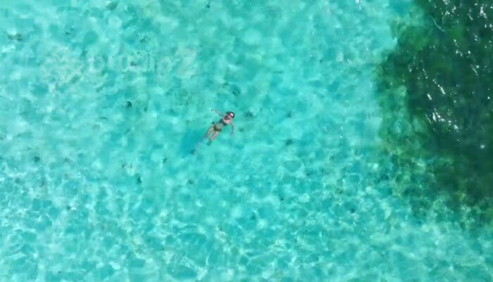 Balabac Islands - Woman Floating on Emerald Waters in Balabac’s Ocean Paradise