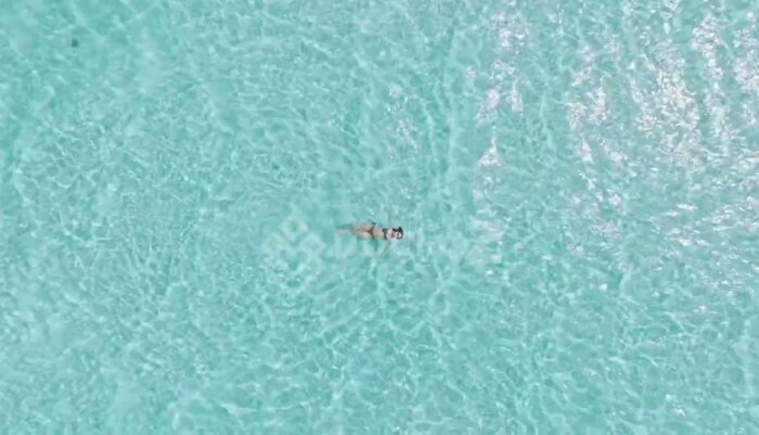 Floating Woman in Balabac Jewel-Toned Clear Ocean Waters