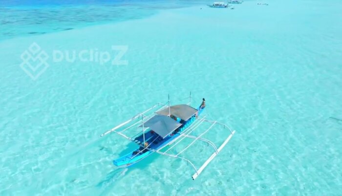 Boat Gliding Over Balabac’s Emerald Waters from Above